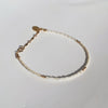 A delicate piece designed with white and pearlescent glass seed beads to add a touch of elegance to any bracelet stack.