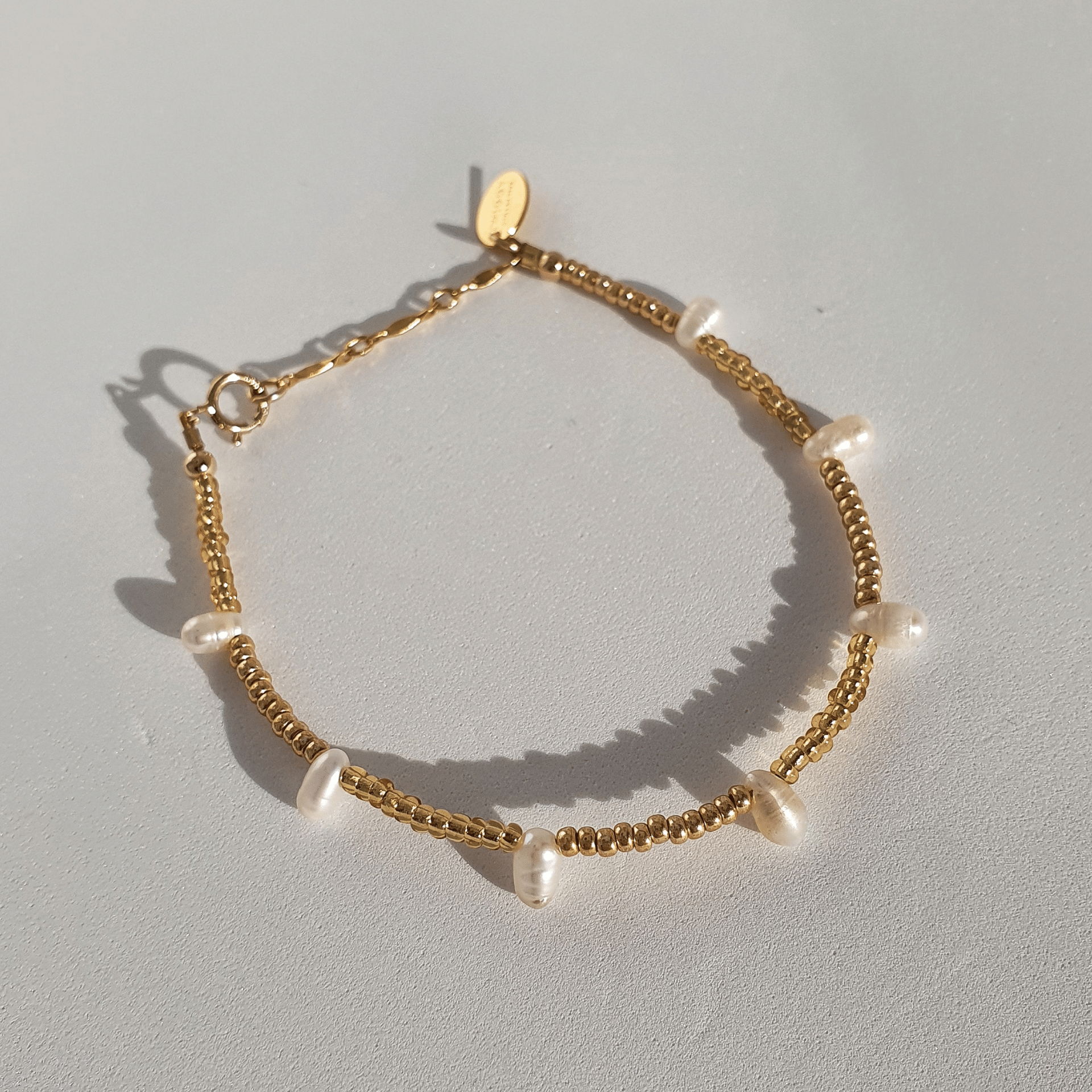 Designed with freshwater pearls, glass seed beads and 14Kt gold-filled beads. A dainty decorative piece - wear on its own for an elegant, feminine feel, or stack it alongside other designs to amp up the look.