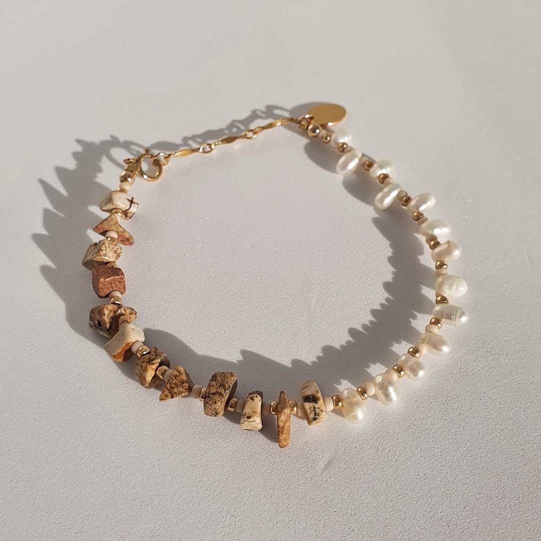 Designed with freshwater pearls, jasper stones, glass seed beads and 14Kt gold-filled beads. A unique, eye-catching design highlighting the perfectly imperfect beauty of these two stunning gemstones.