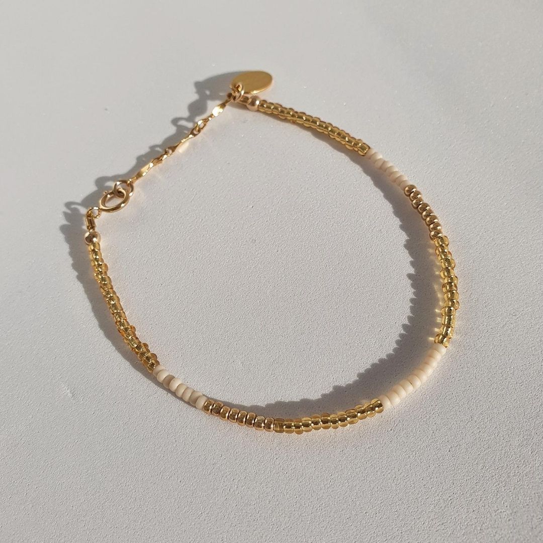 Designed with cream and gold glass seed beads and 14Kt gold-filled beads. Spirited is the perfect layering piece to amplify your stack.